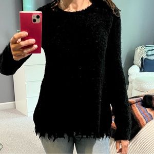 ATM black sweater with frayed hem.